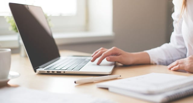manage multiple wordpress sites with glow, photo of girl writing on laptop